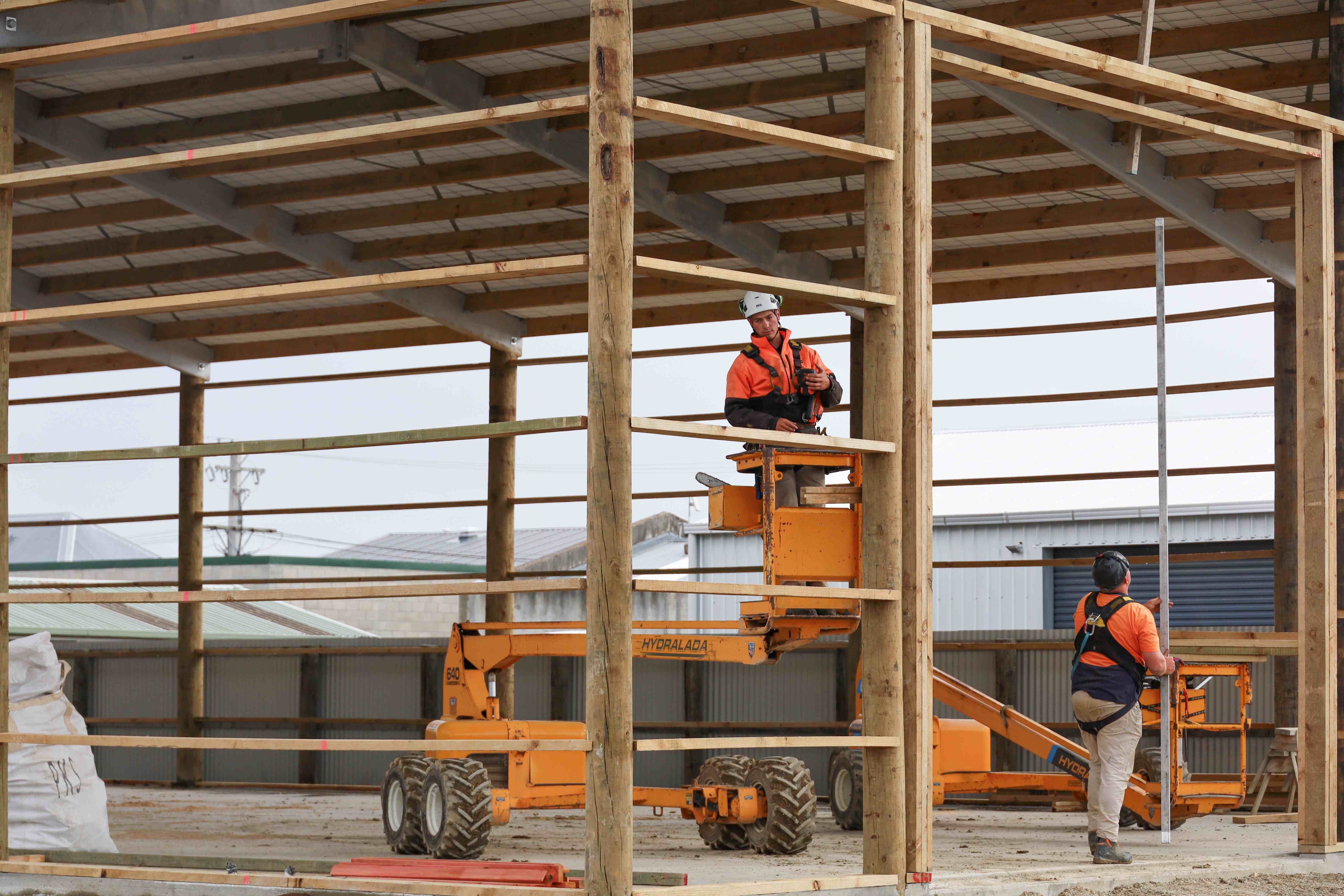 Alpine install team building a pole shed in Southland.