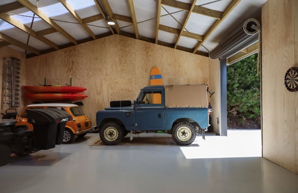 Classic cars inside an insulated, plywood lined Alpine shed